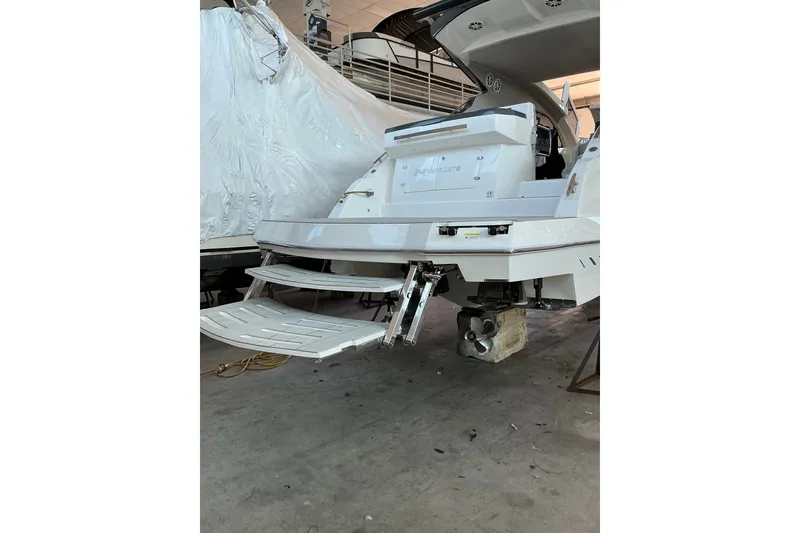 Slide: The Image of 2027 NX Boats 41 Horizon yacht in a workshop, showcasing rear deck and propeller. - 11