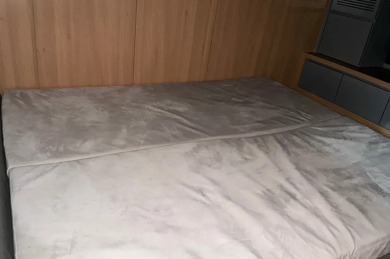 Slide: The Image of Interior cabin bed of 2027 NX Boats 41 Horizon, featuring wooden paneling and modern design. - 35