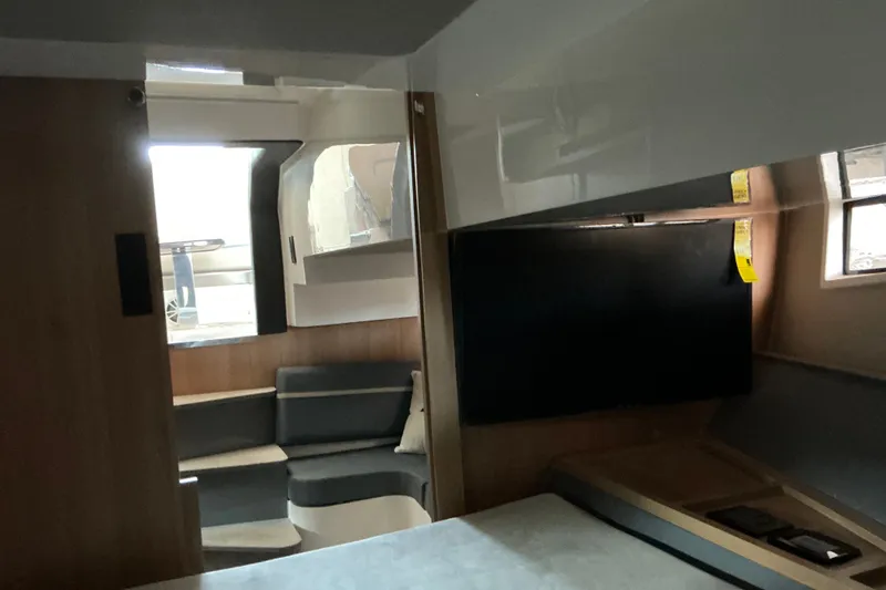 Slide: The Image of Interior of 2027 NX Boats 41 Horizon, featuring modern seating and a flat-screen TV. - 28