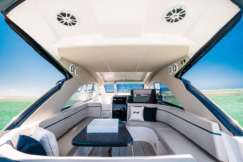 Slide: The Image of Manufacturer Provided Image: 2025 NX Boats 41 Horizon interior, featuring luxurious seating and modern design on open water. - 3