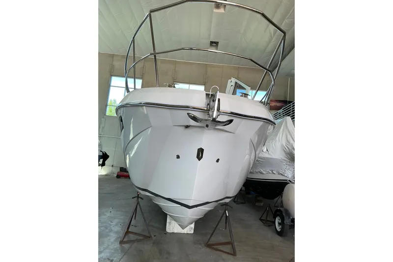 Slide: The Image of 2027 NX Boats 41 Horizon in a garage, front view, showcasing sleek design. - 8