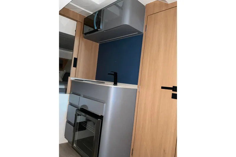 Slide: The Image of Modern kitchenette in 2027 NX Boats 41 Horizon, featuring sleek cabinetry and appliances. - 31