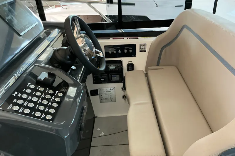 Slide: The Image of Cockpit of 2027 NX Boats 41 Horizon with modern controls and beige seating. - 23