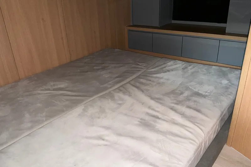 Slide: The Image of Interior cabin of 2027 NX Boats 41 Horizon with wooden paneling and bed. - 34