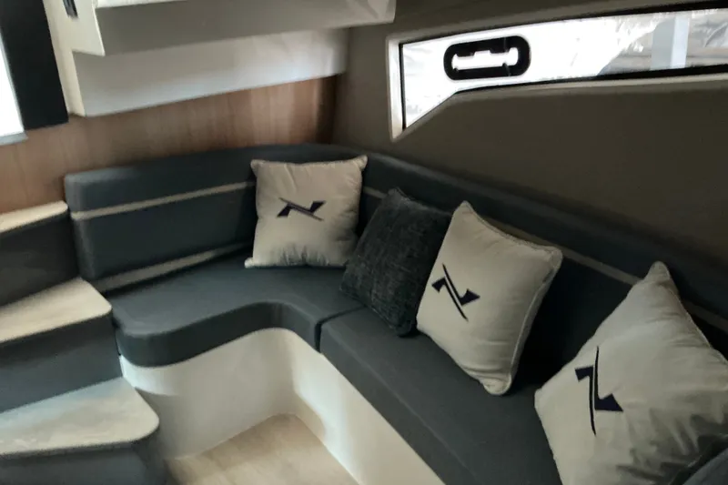 Slide: The Image of Interior of 2027 NX Boats 41 Horizon with stylish seating and branded cushions. - 30