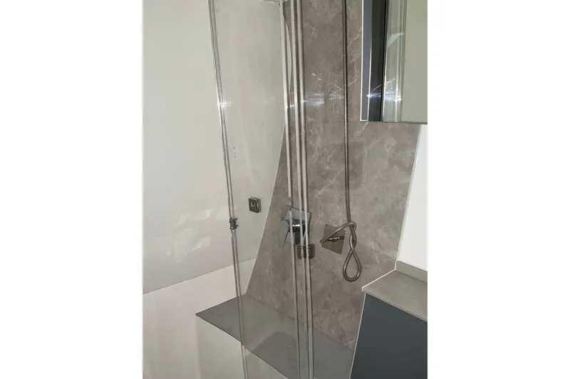 Slide: The Image of Modern shower area in NX Boats 41 Horizon, 2027 model, featuring sleek glass and chrome fixtures. - 38