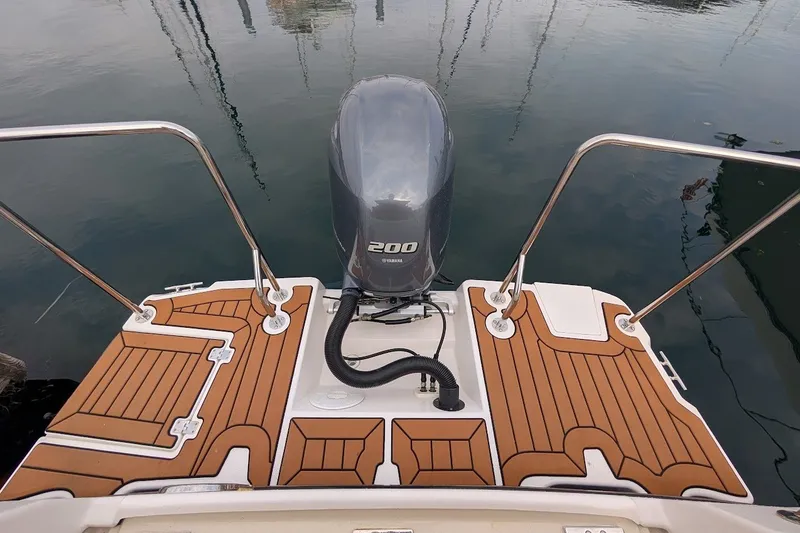 Slide: The Image of 2023 Ranger Tugs boat with Yamaha 200 outboard motor on teak deck. - 24