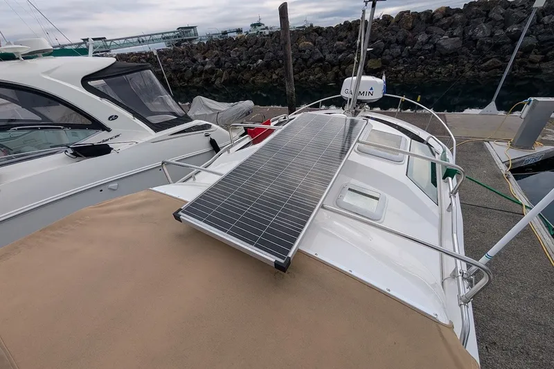 Slide: The Image of 2023 Ranger Tugs boat with solar panel on deck, docked at marina. - 36