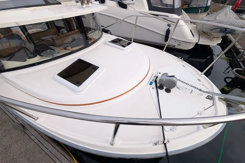 Slide: The Image of 2023 Ranger Tugs boat deck with hatches and anchor, docked at marina. - 2