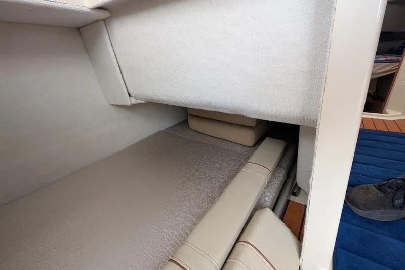 Slide: The Image of Interior cabin of 2023 Ranger Tugs boat with cushioned seating and carpeted flooring. - 22