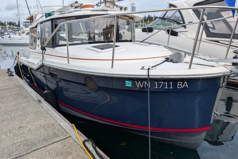 Slide: The Image of 2023 Ranger Tugs boat docked at marina, featuring sleek design and blue hull. - 4