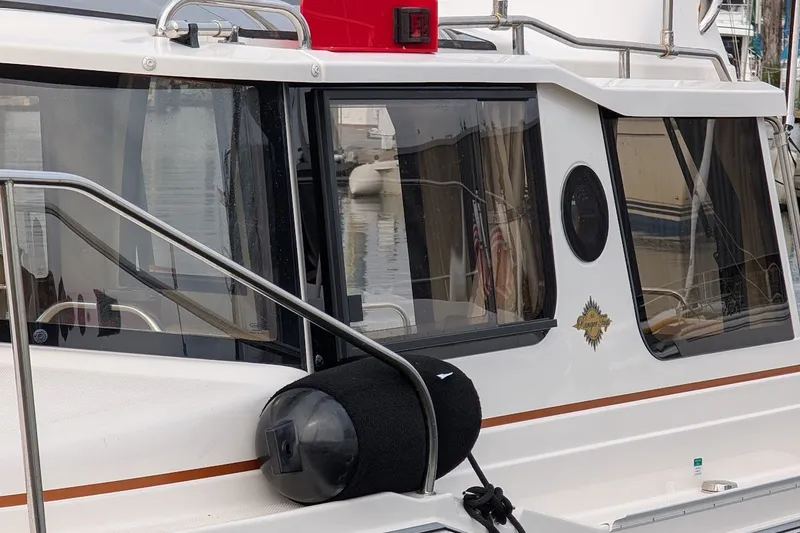 Slide: The Image of 2023 Ranger Tugs boat with fender, docked at marina. - 26