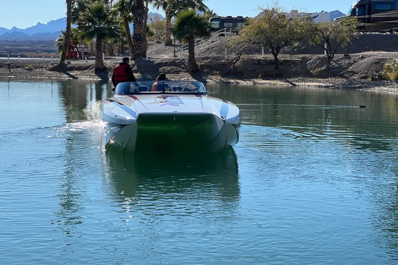 The Image of 2023 Daves Custom Boats M37R cruising on a serene lake with passengers. - 20