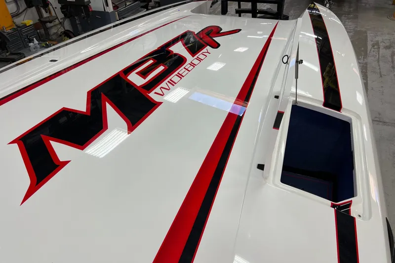 Slide: The Image of 2023 Daves Custom Boats M37R Widebody with bold red and black graphics. - 3