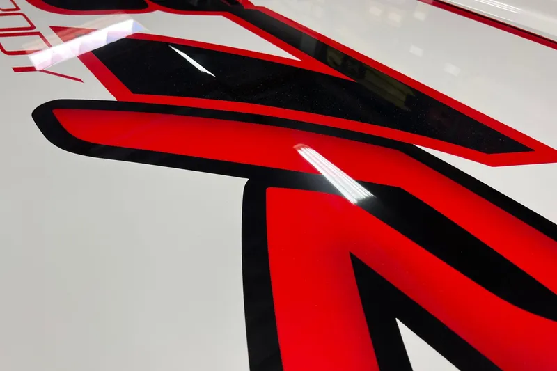 Slide: The Image of Close-up of 2023 Daves Custom Boats M37R with bold red and black graphics. - 4