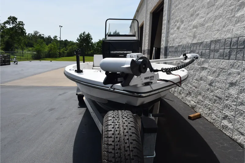 Slide: The Image of 2020 Sportsman Tournament 214 Bay Boat with Minn Kota trolling motor, parked outdoors. - 3