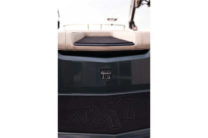 Slide: The Image of 2027 MasterCraft NXT24 boat rear view with logo and seating detail. - 16
