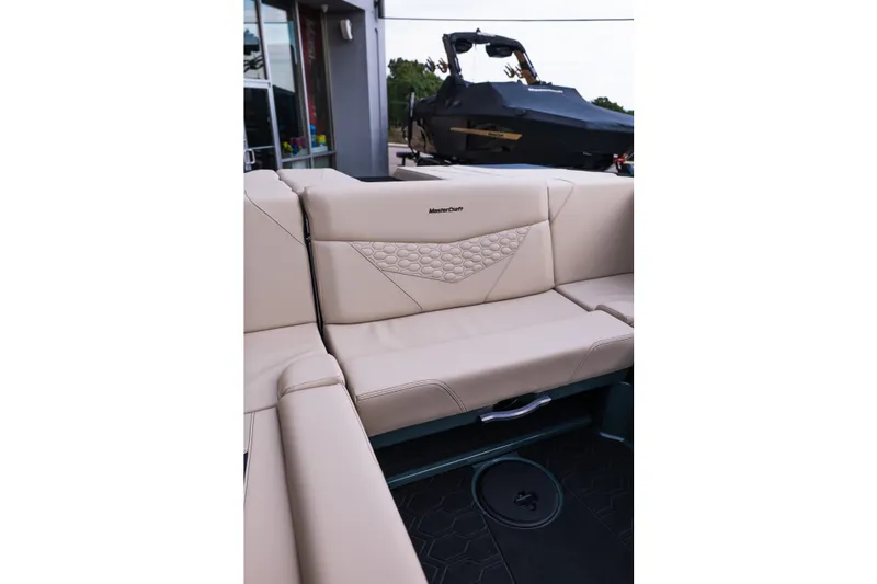 Slide: The Image of 2027 MasterCraft NXT24 boat interior with beige seating and stylish design. - 40