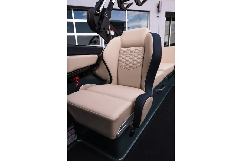 Slide: The Image of 2027 MasterCraft NXT24 boat seat with beige upholstery and honeycomb pattern design. - 31