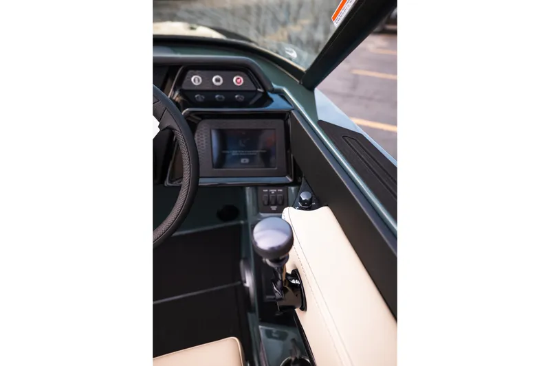 Slide: The Image of Interior view of 2027 MasterCraft NXT24 boat dashboard with steering wheel and controls. - 33