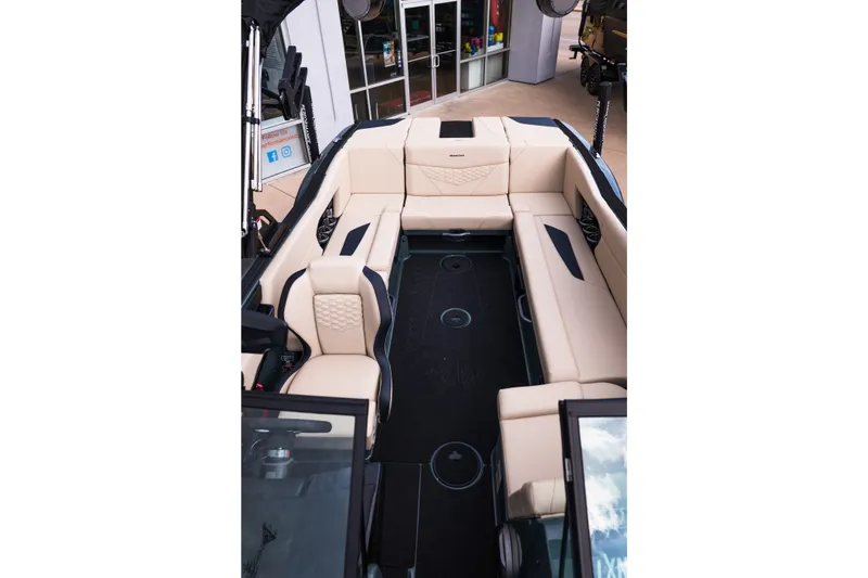 Slide: The Image of 2027 MasterCraft NXT24 boat interior with beige seating and modern design. - 27