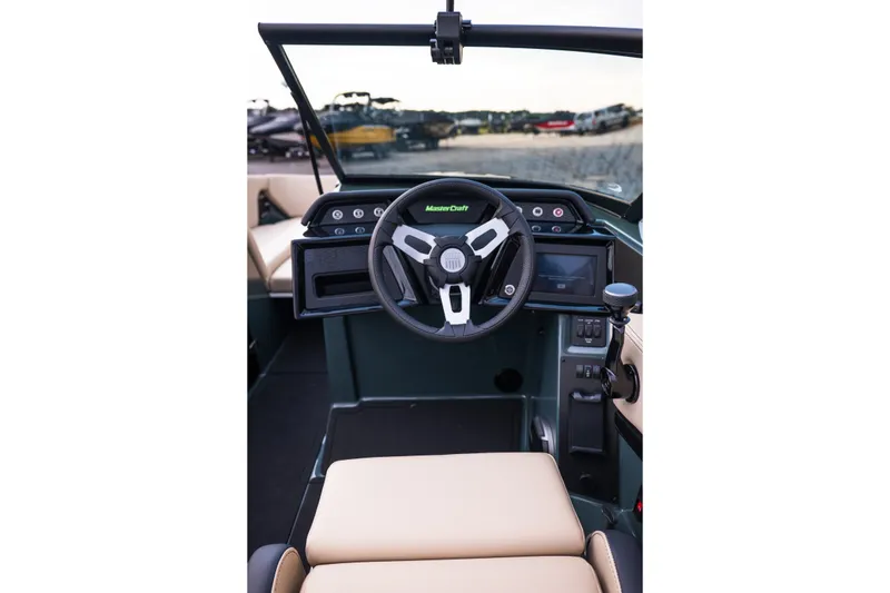 Slide: The Image of 2027 MasterCraft NXT24 boat interior with modern steering wheel and dashboard controls. - 32