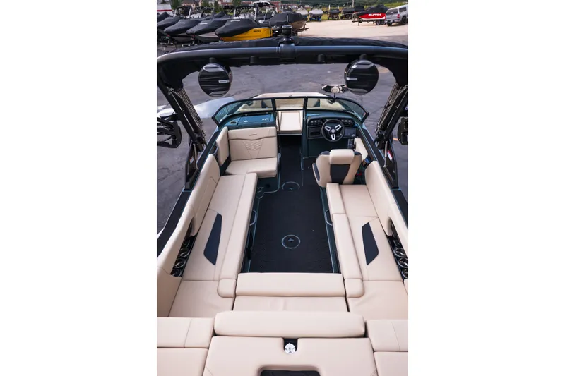 Slide: The Image of 2027 MasterCraft NXT24 boat interior with beige seating and modern dashboard design. - 42