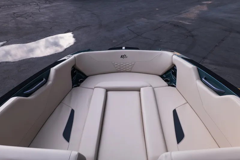 Slide: The Image of 2027 MasterCraft NXT24 boat interior with beige seating and sleek design. - 23