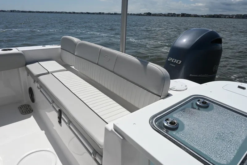 Slide: The Image of 2024 Sea Fox 228 Commander boat interior with Yamaha 200 engine on open water. - 24