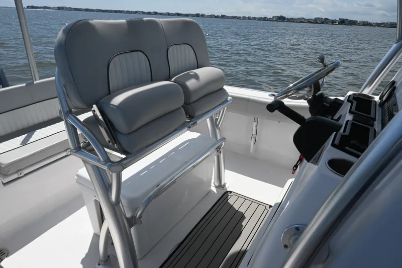 Slide: The Image of 2024 Sea Fox 228 Commander boat interior with dual seating and steering console on the water. - 20