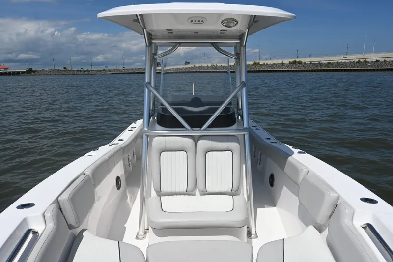 Slide: The Image of 2024 Sea Fox 228 Commander boat on water, featuring sleek white seating and sturdy T-top. - 15