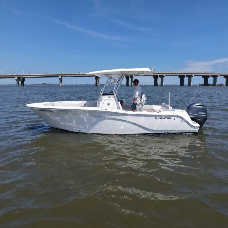 The Image of A 2024 Sea Fox 228 Commander on calm water with a bridge in the background. - 0