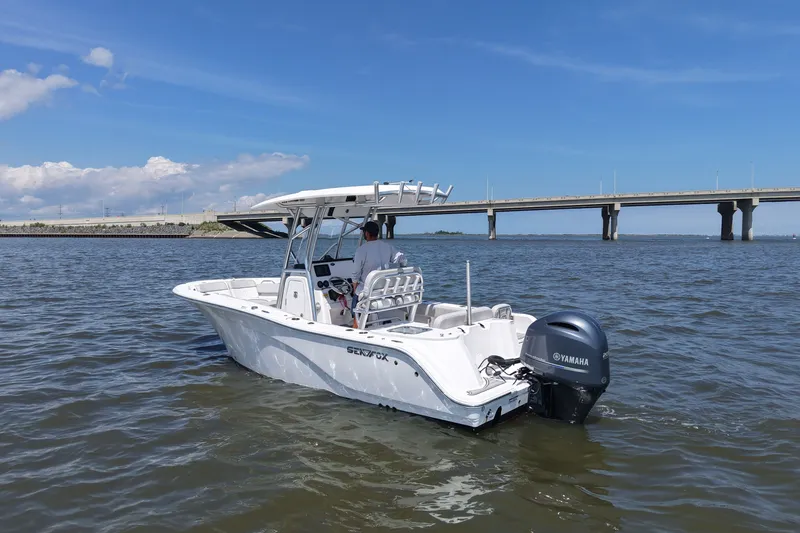 Slide: The Image of A 2024 Sea Fox 228 Commander cruising on calm waters beneath a bridge. - 5