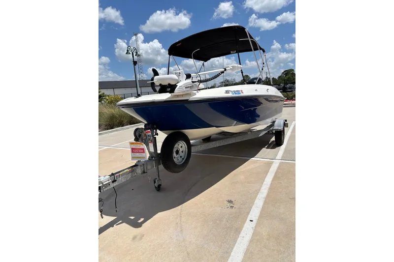 The Image of 2017 Bayliner Element E18 boat on trailer under sunny sky. - 0