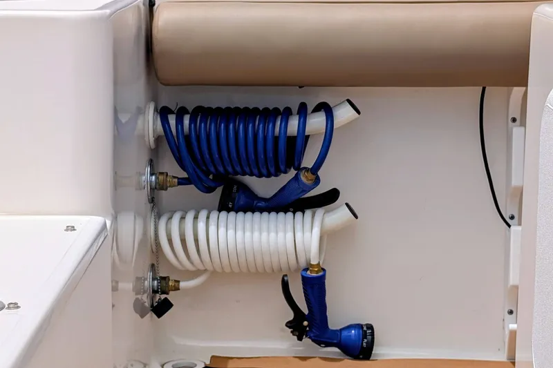 Slide: The Image of Coiled hoses in a 2026 Sea Born LX22 Center Console boat compartment. - 29