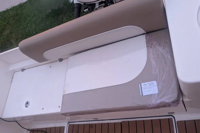 Slide: The Image of 2026 Sea Born LX22 Center Console boat interior with cushioned seating and storage area. - 36