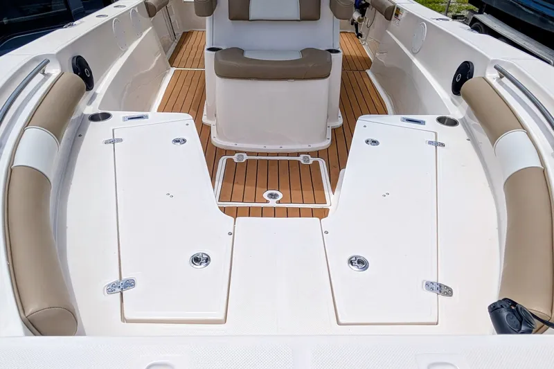 Slide: The Image of 2026 Sea Born LX22 Center Console boat interior with teak flooring and cushioned seating. - 23
