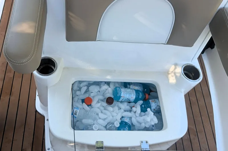 Slide: The Image of Ice-filled cooler with drinks on a 2026 Sea Born LX22 Center Console boat. - 24