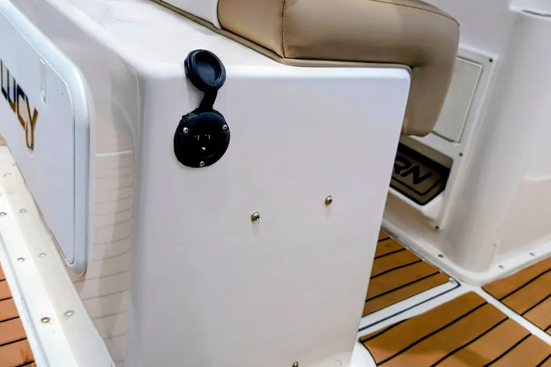 Slide: The Image of 2026 Sea Born LX22 Center Console boat interior with cushioned seating and teak flooring. - 32