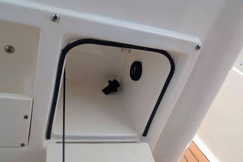 Slide: The Image of 2026 Sea Born LX22 Center Console storage compartment detail with black knob and white interior. - 15