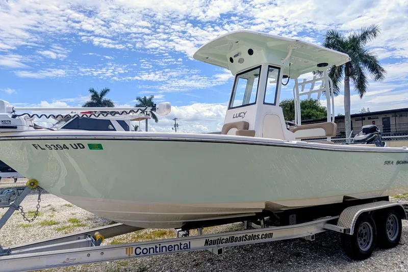 The Image of 2026 Sea Born LX22 Center Console boat on trailer, under a clear blue sky. - 0