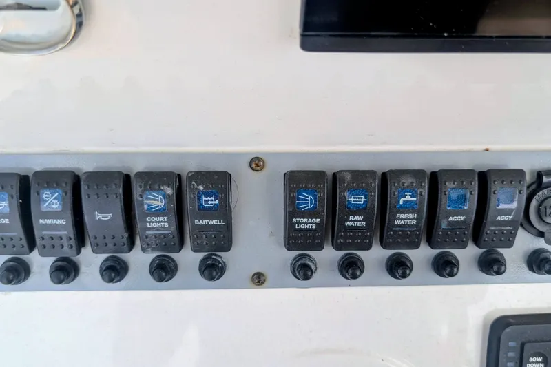 Slide: The Image of Control panel of 2026 Sea Born LX22 Center Console boat with labeled switches. - 17