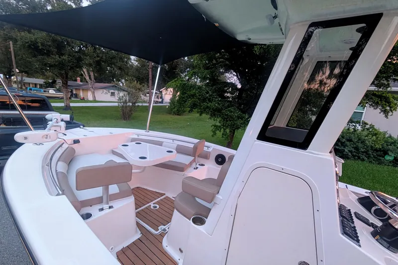 Slide: The Image of 2026 Sea Born LX22 Center Console boat interior with seating and canopy. - 26