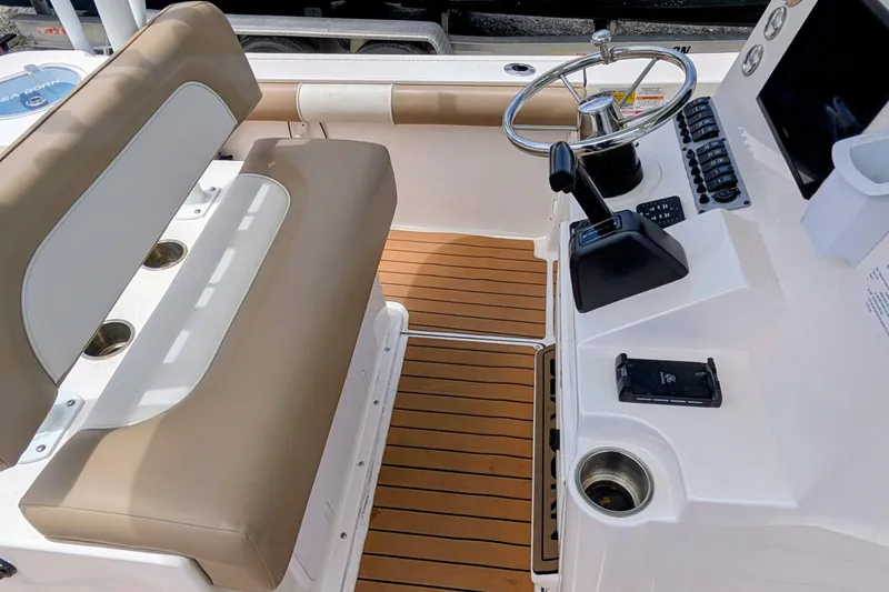 Slide: The Image of 2026 Sea Born LX22 Center Console boat interior with steering wheel and seating. - 21
