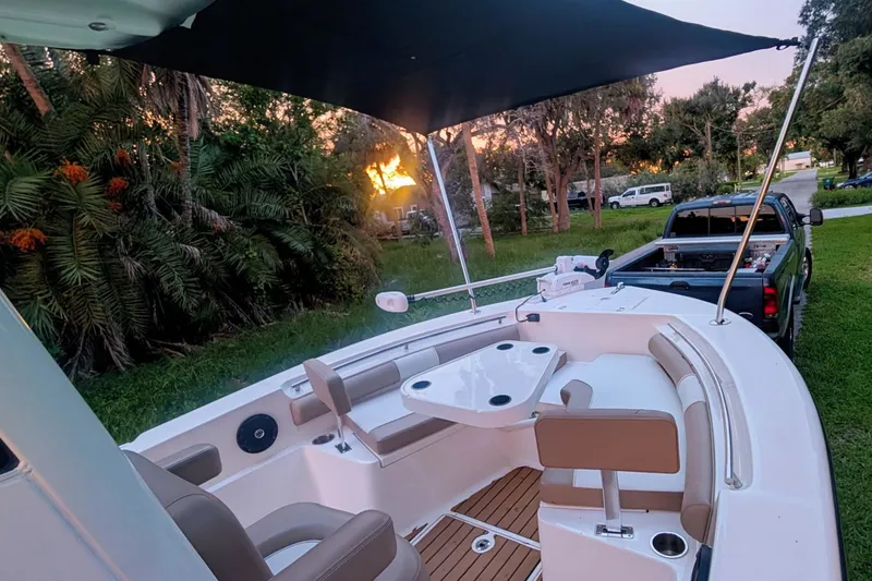 Slide: The Image of 2026 Sea Born LX22 Center Console boat with seating, canopy, and sunset view. - 25