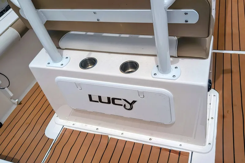 Slide: The Image of 2026 Sea Born LX22 Center Console boat interior with custom nameplate "Lucy" and cup holders. - 31