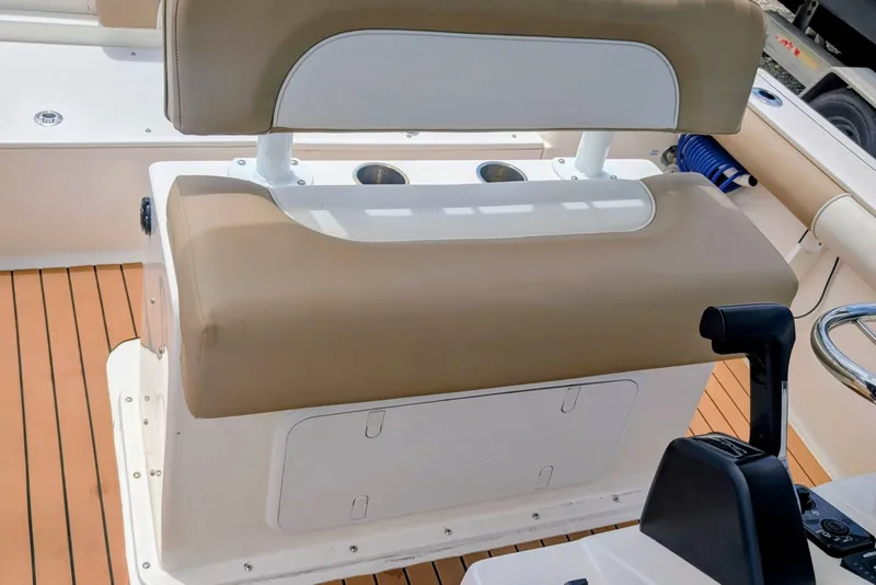 Slide: The Image of 2026 Sea Born LX22 Center Console boat interior with tan seating and control panel. - 22