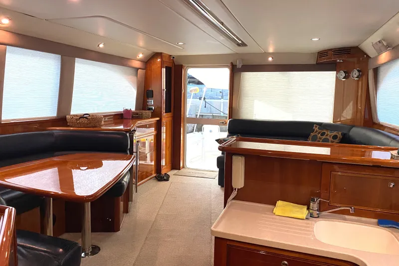 Slide: The Image of Luxurious interior of a 2005 Riviera 51 Flybridge yacht with elegant wood finishes. - 12