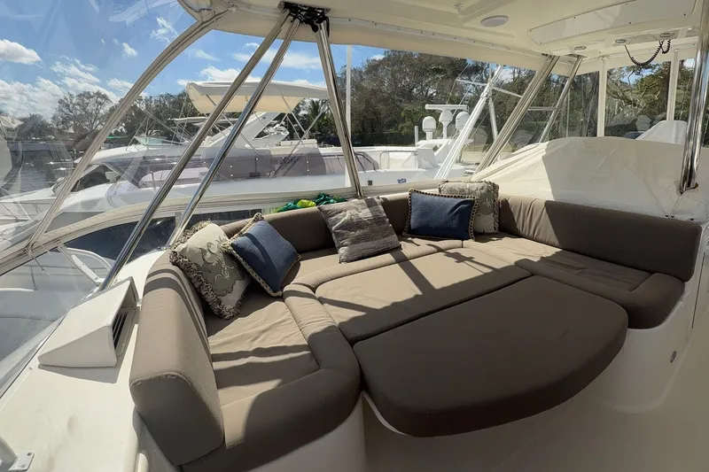 Slide: The Image of Luxurious seating area on a 2005 Riviera 51 Flybridge yacht with plush cushions. - 6