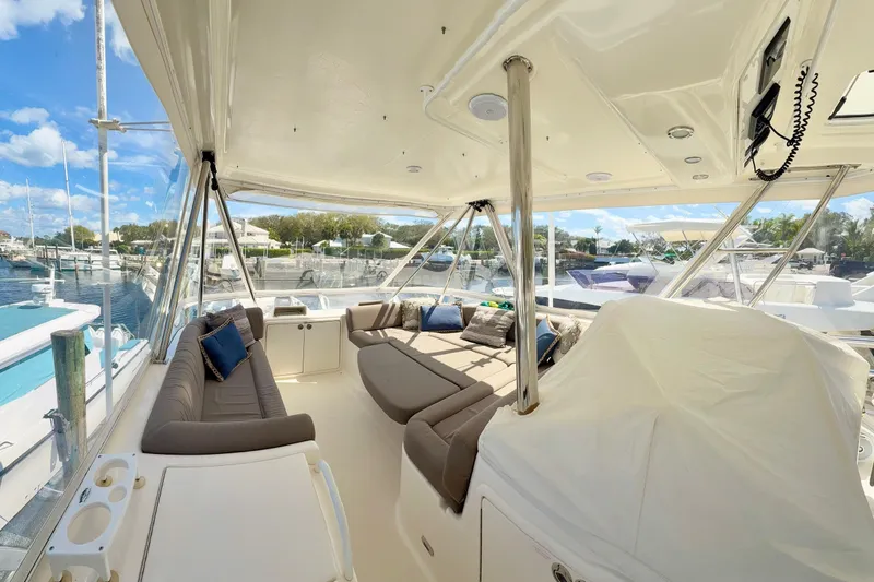 Slide: The Image of Luxurious 2005 Riviera 51 Flybridge yacht interior with plush seating and marina view. - 8